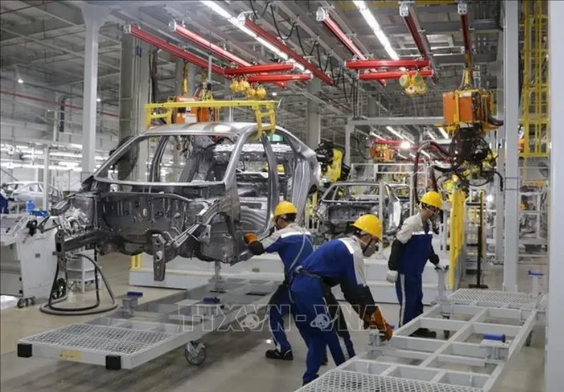 Automobile assembly line in Vietnam, showcasing joint venture production of various international car brands.